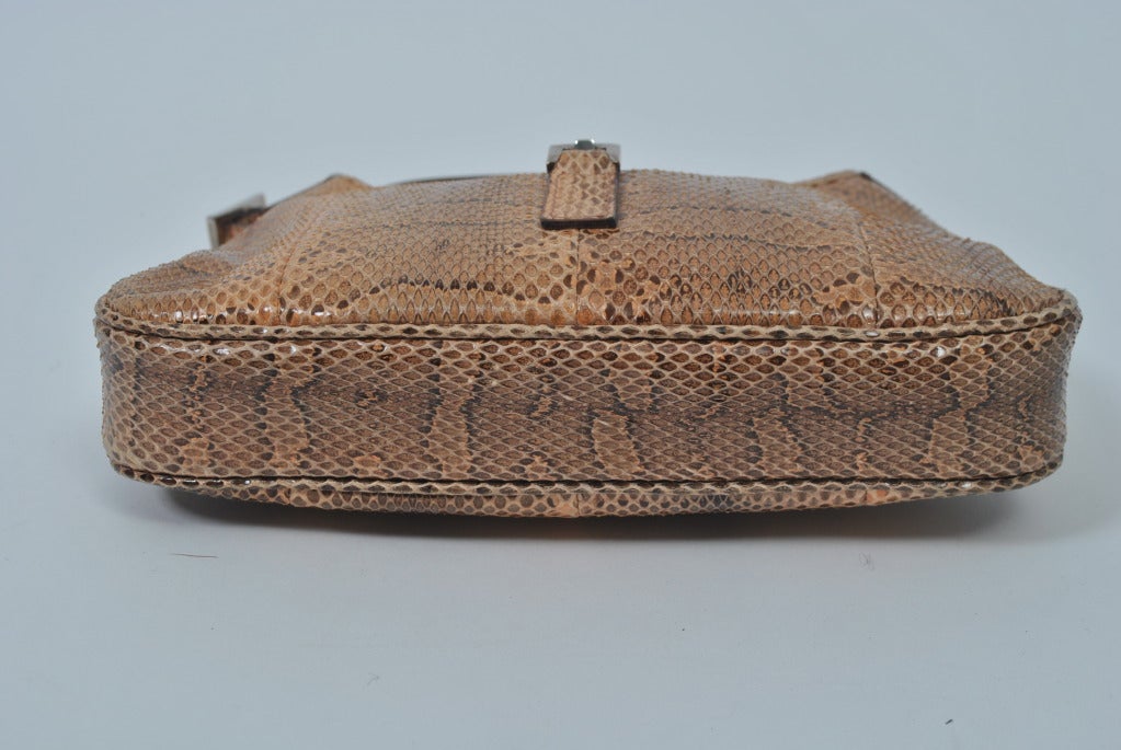 Petite Gucci snakeskin handbag with integrated bucke handle and silver clasp.