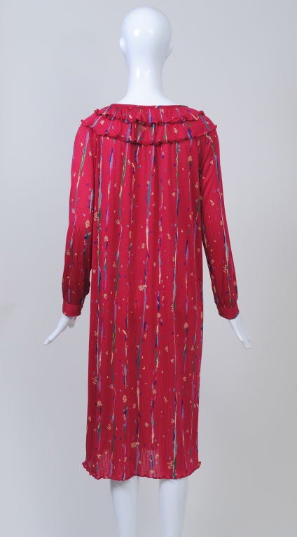 As light as a feather, this Missoni raspberry silk knit with abstract print is perfect for traveling or wearing around town. The shape is a simple body skimming shift that looks great as is or belted. It has long sleeves with button cuffs and a