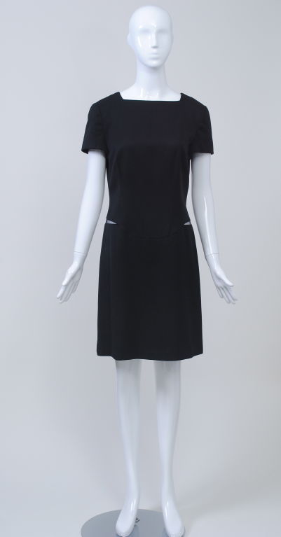 Great LBD by Gianni Versace. Simplicity itself at first glance, until you notice the net inserts at the hipline, revealing a glimpse of skin - a little sneak of sexiness in this basic style. Of fine wool, this square-neck, short-sleeve dress is a