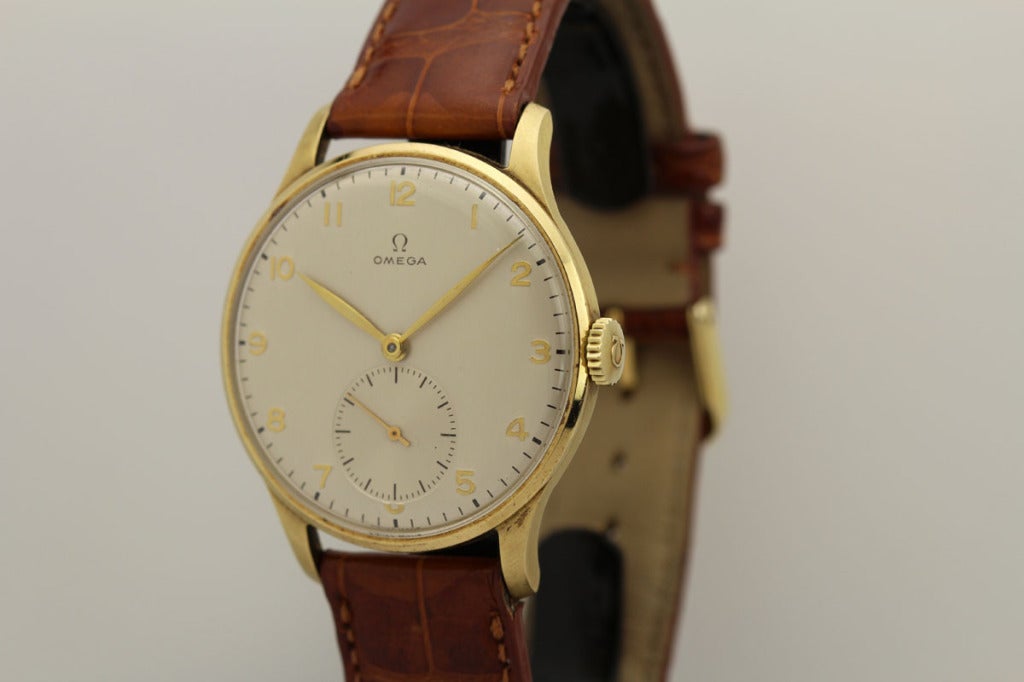 This is a 14k yellow gold oversized Omega wristwatch from the 1950s, measuring 37 mm.

It is a 14k gold watch in mint condition with an original dial that has Arabic numerals and subsidiary seconds. .