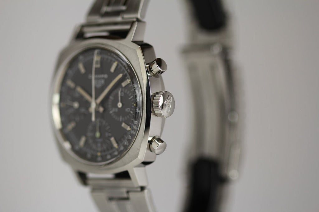 Heuer stainless steel Camaro Chronograph wristwatch with a black dial, 30 minute and 12 hour registers, and tachometer scale. This has a manual-wind Valjoux caliber 72 movement.