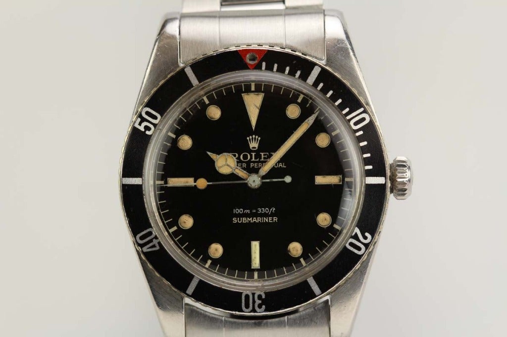 This is a great example of the Rolex James Bond reference 6536/1 from the late 1950s. The stainless steel case has never been polished and the dial is a perfect shiny gilt dial with no cracks or flaws. The original period bezel insert with the red