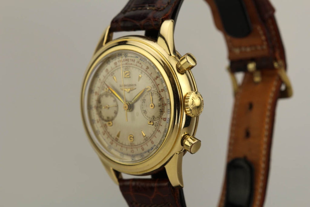 This is a beautiful example of a Longines chronograph wristwatch in 14k yellow gold from the 1950s. It has a very pleasing three-color original dial and heavy gold waterproof case. The watch is powered by Longines caliber 30CH. This is a highly