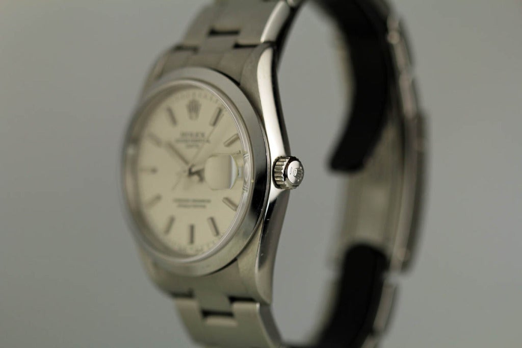 Rolex stainless steel Date wristwatch, Ref. 15200, with brushed dial, luminous dot and baton markers, date aperture, smooth bezel, automatic movement, stainless steel case and bracelet.
