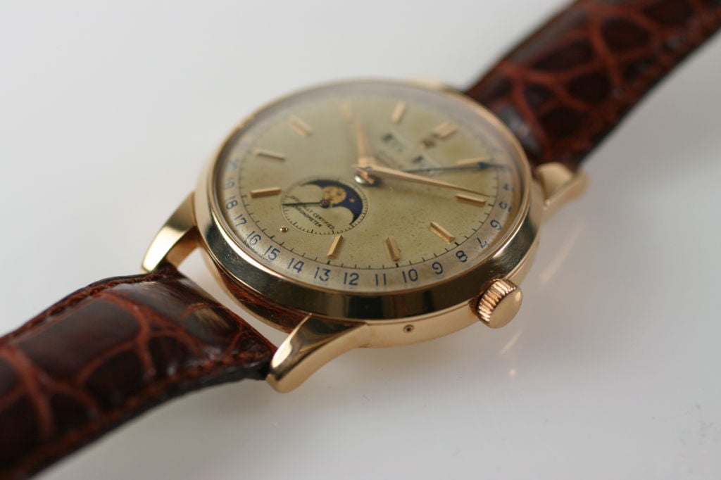 This is an extremely rare and large 18K pink gold automatic triple calendar Rolex moon phase reference 8171 with an automatic movement on a Wempe strap.