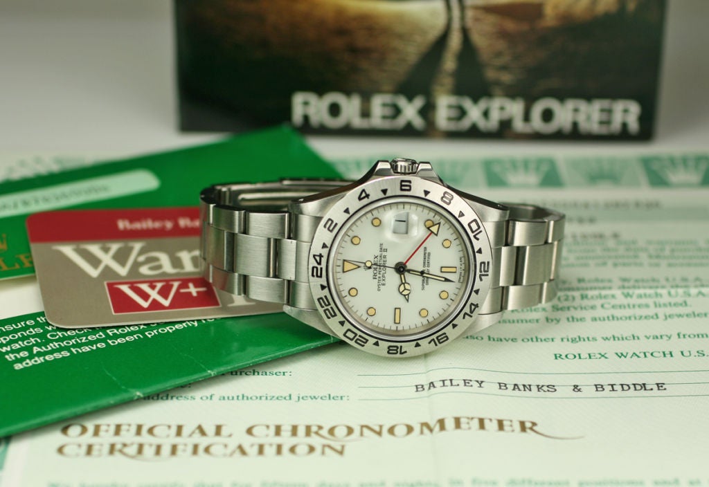 This is a new old stock version of the  Rolex Crème Dial Explorer 2 from the 1980s.  It has a great look with toned luminescent markers..  The watch has the original sticker on the back and comes with the original box and papers.