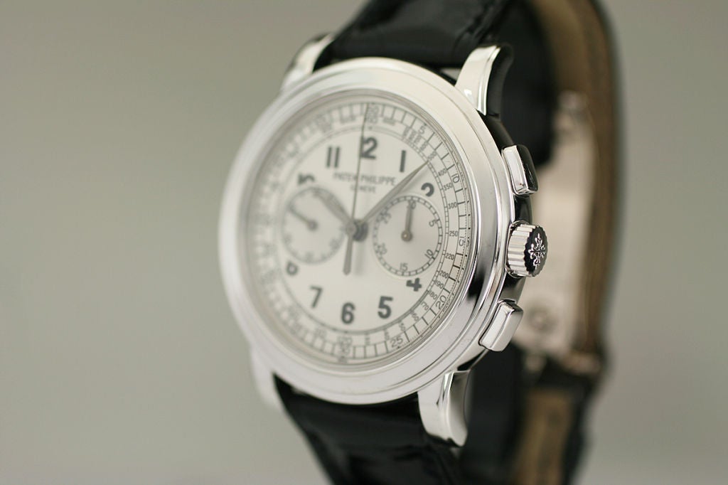 This is the Patek Philippe reference 5070 in white gold. It is a manual wind oversized watch with a two register chronograph function. This watch is in excellent condition and comes with the original box and papers. This watch has become quite