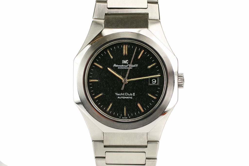 This IWC Yacht Club II in stainless steel with a screw back case has a black dial, applied silver pointy markers, baton hands, center sweep second hand, date aperture. The unusual bezel is beveled and octagonal in shape. This automatic watch is on a