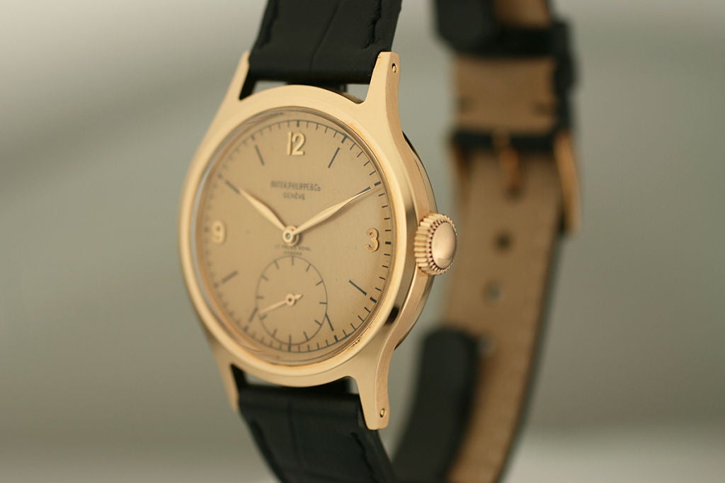 This is a highly collectible Patek Philippe reference 565 in 18k rose gold.  The watch is in excellent condition and has a rare color combination of a rose gold case with a pink color dial.  Another rare feature of the watch is the fact that it was