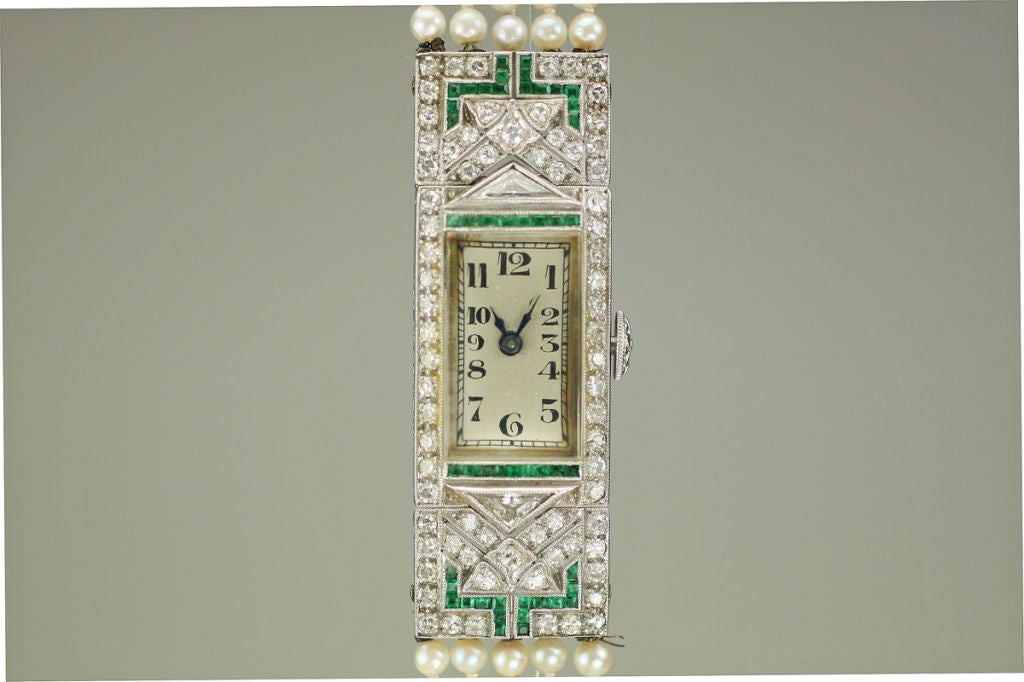 This is a beautiful platinum Art Deco watch with a pearl braclet. The case and movment are signed H. Wheeler.