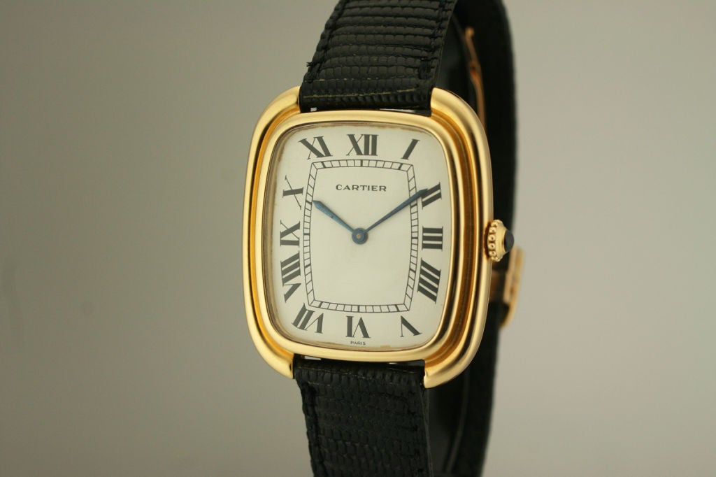 This is an oversized yellow Cartier tank watch 