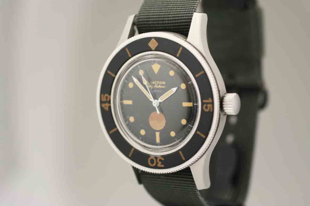 This is an original Blancpain Fifty Fathoms Milspec dive watch from the 1950s. This is a very unusual watch made with military specifications. It has an original dial with a moisture indicator located above the 6 position. This watch is highly