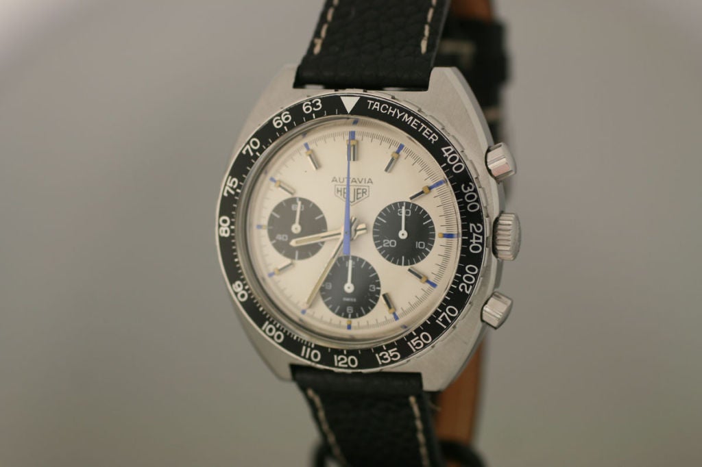 This watch is a Tag Heuer Autavia chronograph Jo Siffert edition. Usually, the Autavia comes with a black dial, but the Jo Siffert comes with a white dial making it quite rare.  The dial also a blue seconds hands for the chronograph as well as a