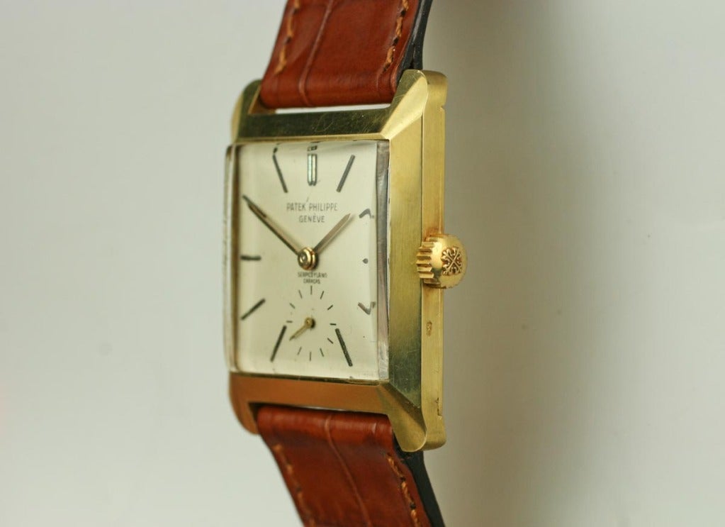 Patek Philippe Ref. 2488 in an 18k yellow gold square case, an original silver dial with radial gold indexes, subsidiary seconds at the 6 o’clock, and a manual wind movement. 28x35mm