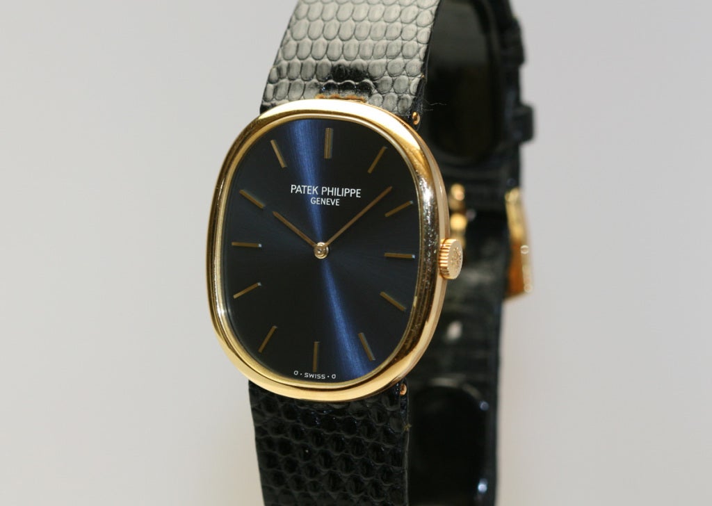 This is a Patek Philippe 18k yellow gold Ellipse wristwatch, Ref. 3848, with beautiful blue dial, gold baton markers and hands, 