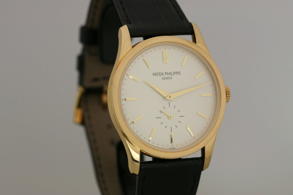 Patek Philippe 18k yellow gold Calatrava, Ref. 5196J/001, on black Patek Philippe strap and 18k yellow gold tang buckle. Comes with box and papers.