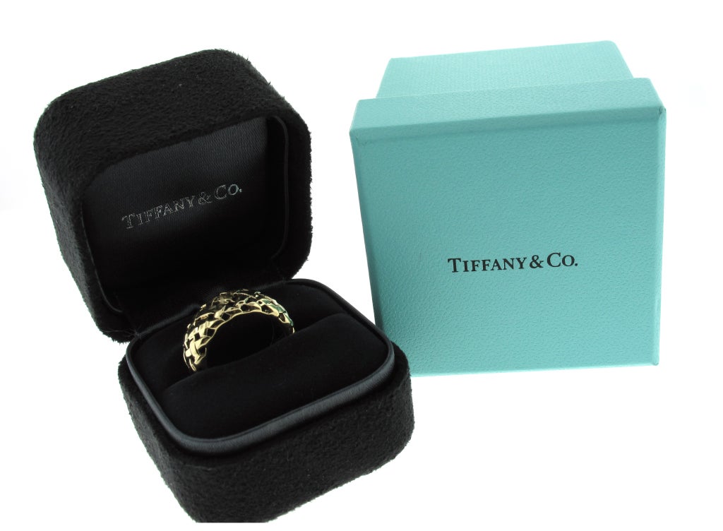 This Tiffany & Co. Vannerie ring is 18 karat yellow gold and features a stunning basket weave pattern. The ring measures about 9mm in width.  This ring is a size 5.5 and CANNOT be sized.