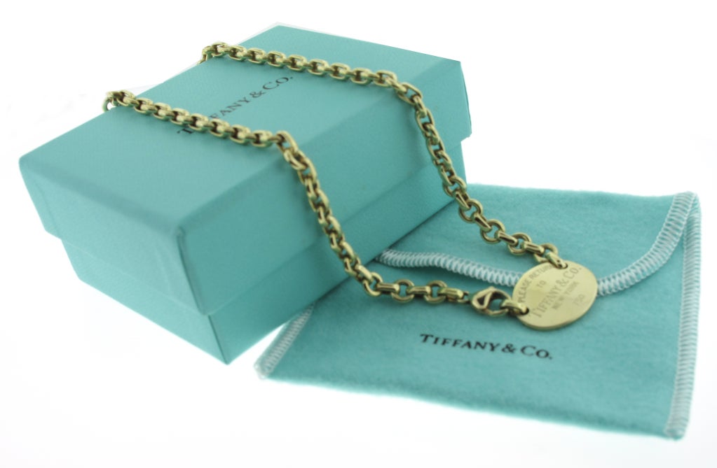 This beautiful Tiffany & Co. Return to Tiffany 18 karat yellow gold necklace measures 16 inches in length. The center featured medallion measures 3/4 of an inch in height and just an inch in width.  The necklace weighs 45.3 grams.