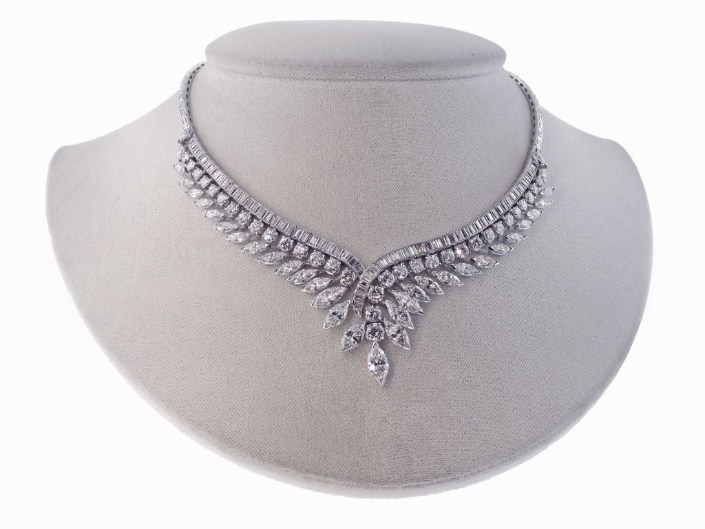 This stunning statement necklace is sure to be the most fabulous piece in your jewelry collection.  Thirty-four marquise diamonds with a total weight of 12.35 carats give this necklace an ornate leafy feel and 6 carats of round diamonds accent the