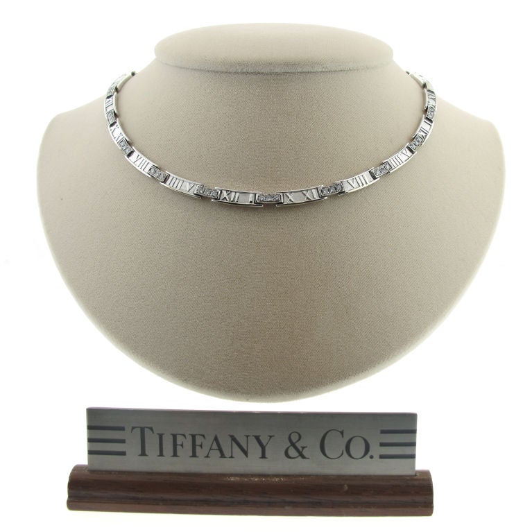 Add some shimmer and sophistication to your jewelry collection with this gorgeous Tiffany & Company 18-karat white gold and diamond Atlas necklace.  Thirty diamonds equaling 1.50 carats sparkle gracefully while beautiful white gold roman numerals