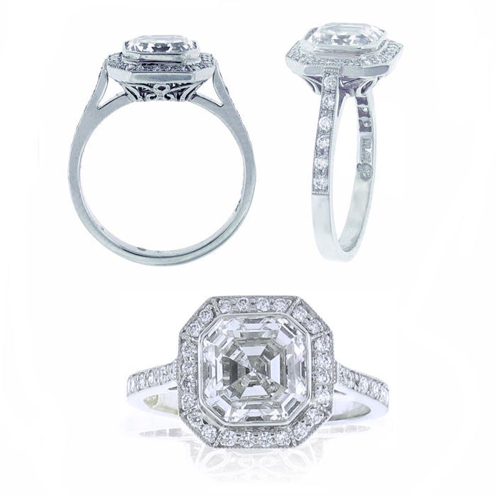 Set in platinum this ring features a center Asscher cut diamond weighing 2.07 carats. The diamond is G color and VS1 clarity G.I.A. There are thirty six round micro-pavé set diamonds weighing .24 carats. The ring is a custom design and handmade by