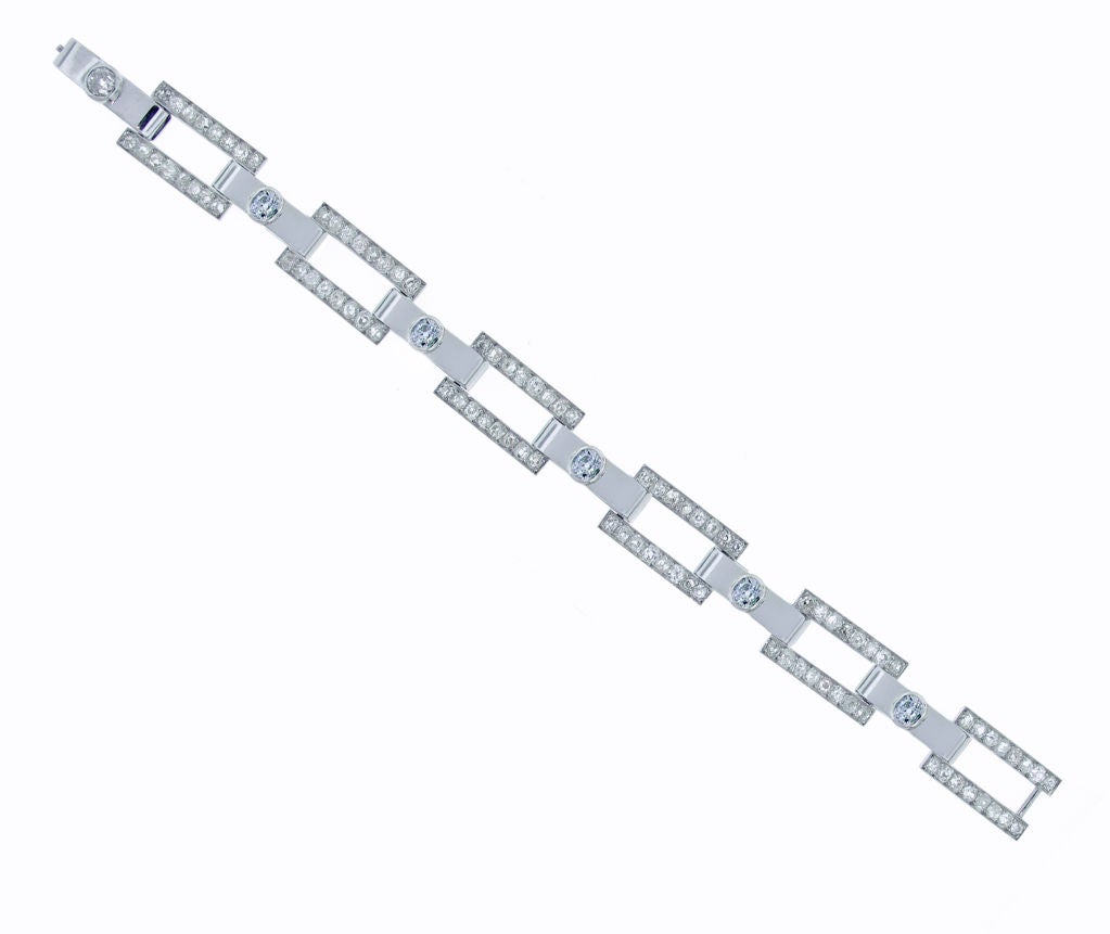 An early example of French Art Deco Jewelry the bracelet consists of six old mine cut diamonds weighing 3.50 carats and ninety-six old mine cut diamonds weighing 5.75. The front panels are white gold and the open rectangles are platinum. White gold