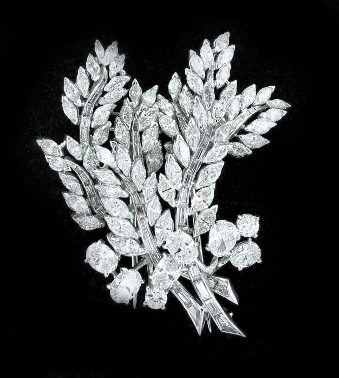 A striking array of shimmering diamonds this breathtaking brooch embraces round, oval, baguette and marquise cut diamonds in a fabulous interpretation of a cluster of leaves. Containing over ten and half carats of diamonds and handmade in platinum