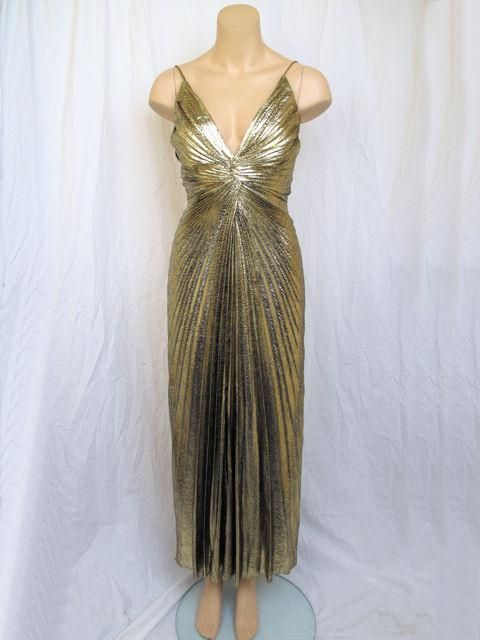 This is the best of Travilla!<br />
* This gorgeous gown has a sexy sunburst pleated design. <br />
* The gold metallic fabric has a snakeskin print.<br />
* It closes with a zipper down the back.<br />
<br />
Measurements:<br />
Sleeves NA