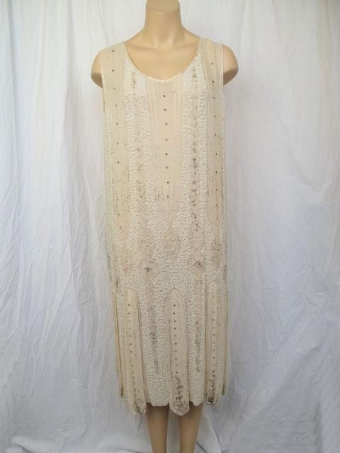 This is a ivory silk 1920's flapper dress.<br />
* It's covered in tiny white pearls, glass beads & rhinestones.<br />
* It has a car wash hemline.<br />
* It's unlined and slips over the head to wear.<br />
<br />
Measurements:<br />
Sleeves