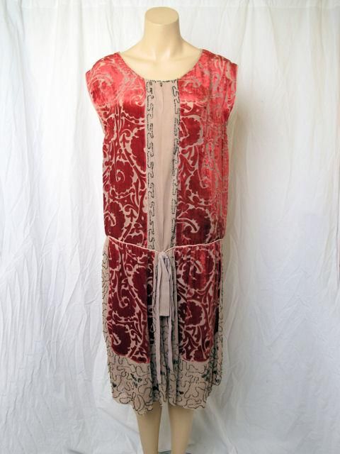 This is a tan silk with burned out red velvet & black glass beads 1920's flapper dress.

* It has a pleat down the front.
* It has a drop waist with a tie detail.
* The skirt bottom has four velvet panels over a tan silk under skirt.
* It's