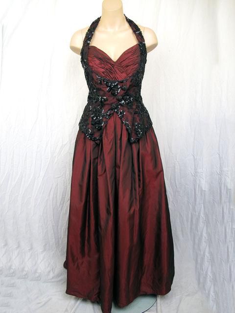 Description: You'll definitely turn heads in this Victor Costa halter ball gown.

* It's burgundy with a black sequin lace vest styled bodice.
* The full skirt has black crinoline underskirt.
* It closes with a zipper down the back & hooks at