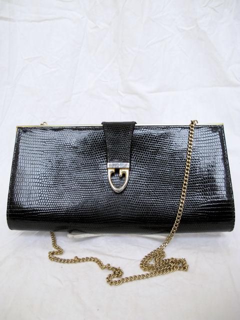 Here is this 100% authentic Gucci bag.<br />
<br />
* It's made of black lizard snake skin with a gold strap.<br />
* You can tuck the strap away & carry it like a clutch.<br />
* It has gilt G hardware with a hidden snap underneath.<br />
*