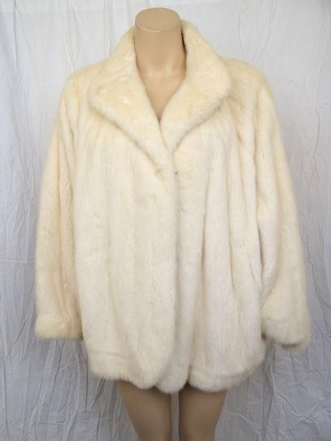 Here is a wonderful Oscar de la Renta white mink jacket.

* The bat-wing sleeves really make this a stunner.
* It closes with two hook & eye closures & has two pockets.
* It has a french hem. 
* Please refer to the measurements provided for an