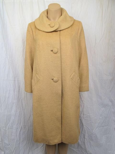 Here is this lovely Fabric of France swing coat by Lilli Ann.

* It's a classic swing coat that has a roll collar & closes with three covered buttons.
* It has two slanted front side pockets.
* It's fully lined in tan satin & made Fabric of