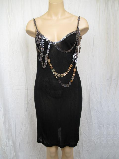 Here is the sexy number by Jean Paul Gaultier.

* This slip dress is embellished with buttons galore.
* It's in excellent condition & made of 100% rayon.
* It's marked a size large but please refer to the measurements provided for an accurate