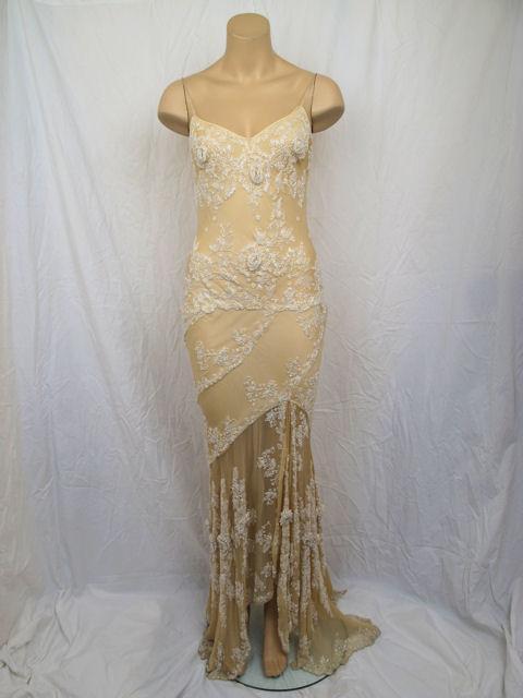 Here is a very sexy, heavily beaded pale peach gown by Eavis G. Brown. 

* It's has floral design white beading throughout.
* It has spaghetti straps & laces up the back.
* It's form fitted with an uneven hemline.
* It's in excellent condition