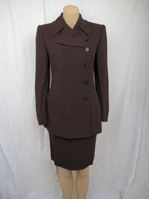 Here is this stunning Gucci brown pinstriped skirtsuit that will be perfect for that next big job interview.

* The notched collar & off-centered button closure really makes this suit a standout.
* The jacket also has two patch pockets on one