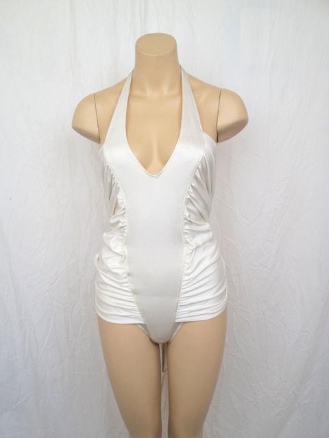 Here is a sexy Versace ivory halter bathing suit.

* It has a deep V neckline & ties at the neck.
* It has ruching down the front with attached ties that tie in the back.
* It's in great condition with no stains or odors.
* It's made of 80%