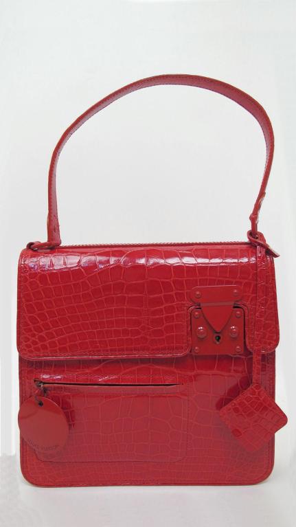 Here is this amazing 100% authentic, limited edition Louis Vuitton Squary red alligator bag. It is a rare and fabulous find for all of you Louis Vuitton Collectors!

* It has a single strap with a zipper pocket on the front.
* It closes with a
