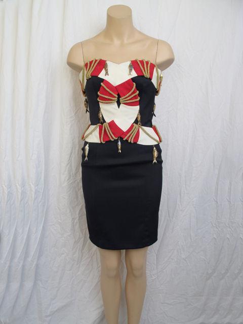 Here is a rare Moschino Couture Cruise Me Baby strapless dress.

* It's navy blue with red, white & gold roping with fish detailing.
* It's lightly boned in the bodice for a secure fit.
* It's fully lined & closes with a zipper down the back.
*