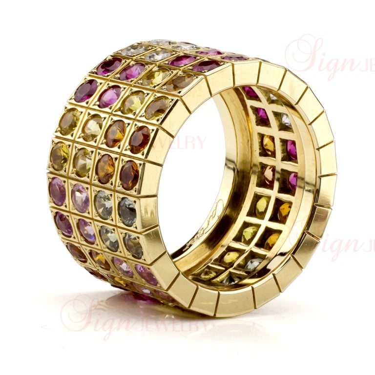 A colorful masterpiece from Cartier. This stunning ring is made in 18k yellow gold and set with natural diamonds and natural multicolor sapphires in an array of bright and fun colors - orange, pink, light blue, yellow, and fuchsia - a feast for the