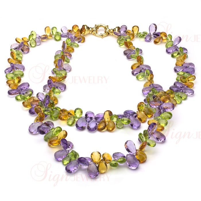 This exquisitely colorful two-strand necklace is composed of briolette-cut purple amethysts, yellow citrines, and green peridots - all the stones are natural, lively, and with lots of multi-color sparkle. Completed by an 18k yellow gold clasp.