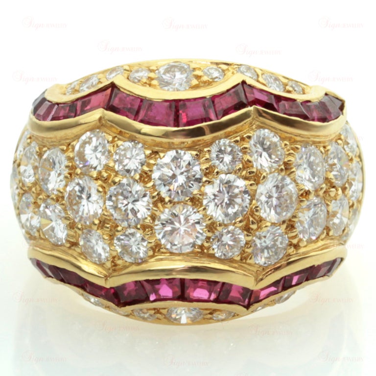 This gorgeous Van Cleef & Arpels ring is pave-set with sparkling round diamonds elegantly edged with square calibre-cut rubies chanel-set in 18k yellow gold. Circa 1989. A majestically elegant design.
17mm (11/16") Width.
Ring Size 6.5 -