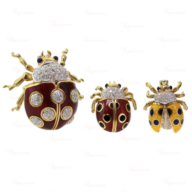 This set of 3 adorable and classic Tiffany & Co. ladybugs is made in 18k yellow gold and features sparkling round diamond bodies pave-set in platinum, blue sapphire eyes, transclucent red and yellow enamel wings with with black & blue enamel spots