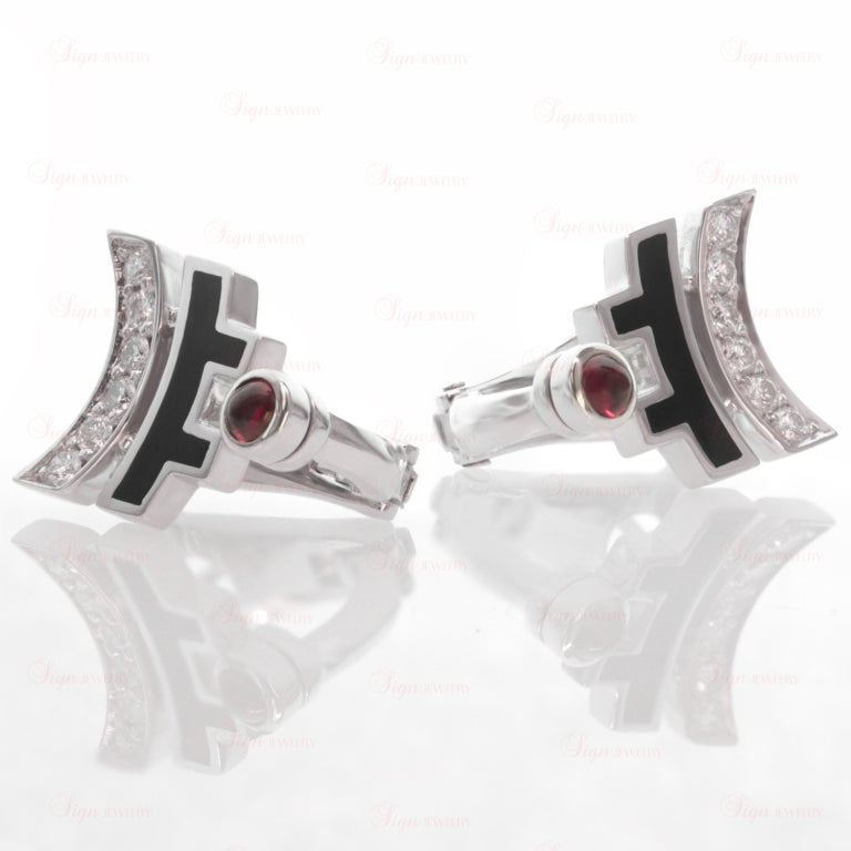 Inspired by Chinese aesthetics and Art Deco geometry, these elegant arched earrings from Cartier's Le Baiser Du Dragon collection are made in 18k white gold and accented with black lacquer, sparkling round diamonds, and round cabochon rubies. Circa