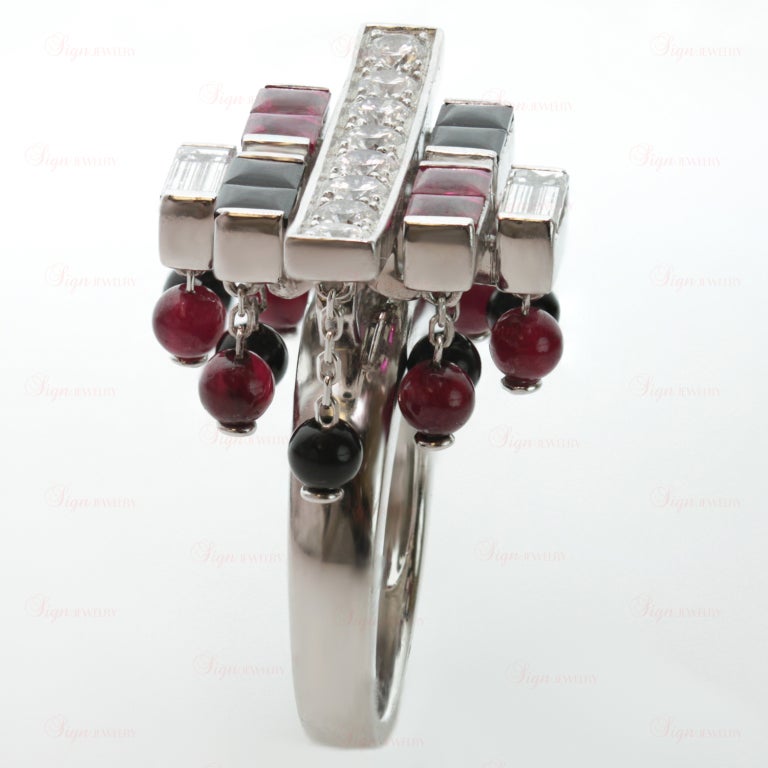 Inspired by the fusion of Chinese culture and Art Deco design, this fabulous ring from Cartier's Le Baiser Du Dragon collection is made in 18k white gold and features red rubies and black onyx, cut as cabochon beads and faceted square-cut stones.