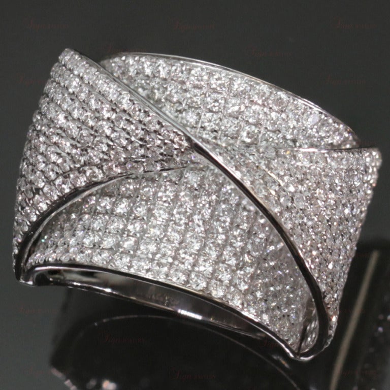 This modern ring is made in 18k white gold and features a unique geometric pattern pave-set with an estimated 4.18 carats of sparkling round diamonds. Chic and fabulous.
Dimensions: 16mm (5/8