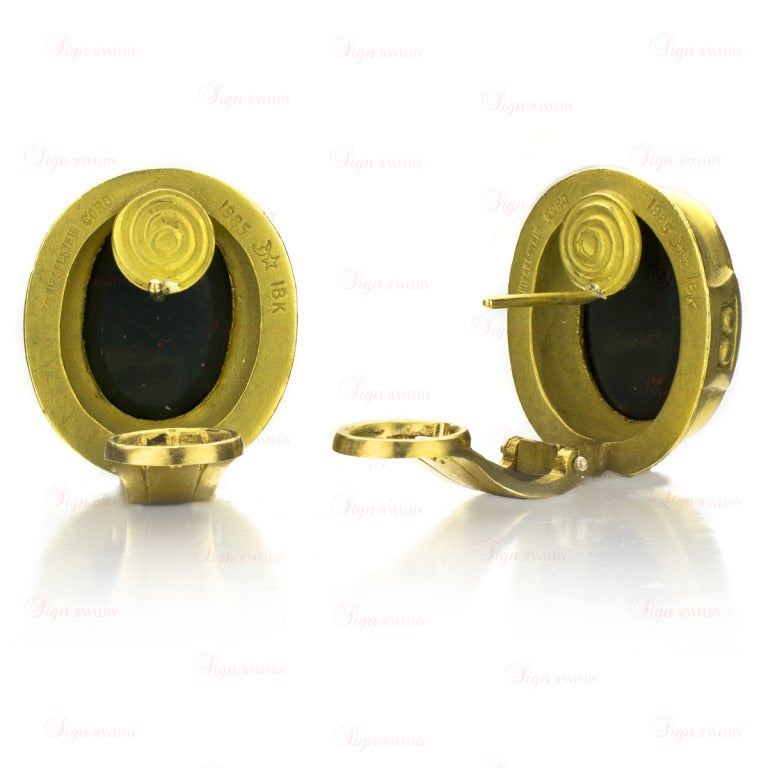 Authentic oval button earrings from Kieselstein-Cord, circa 1985. Made in 18k yellow gold and bezel-set with natural oval 11mm x 15mm green agate stones featuring a lasered intaglio of a  long-haired nymphs. Completed by posts with French clips.
