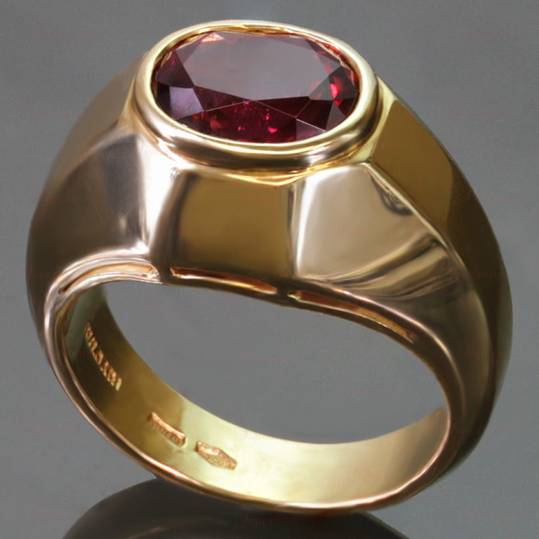 This exquisite Bvlgari ring features an oval 8.0mm x 10.0mm faceted sparkling rubellite of an estimated 3.0 carats bezel-set in 18k yellow gold. A timeless classic design. Ring Size is 6 - EU 52. Resizable. Sizing fees will be provided upon request.