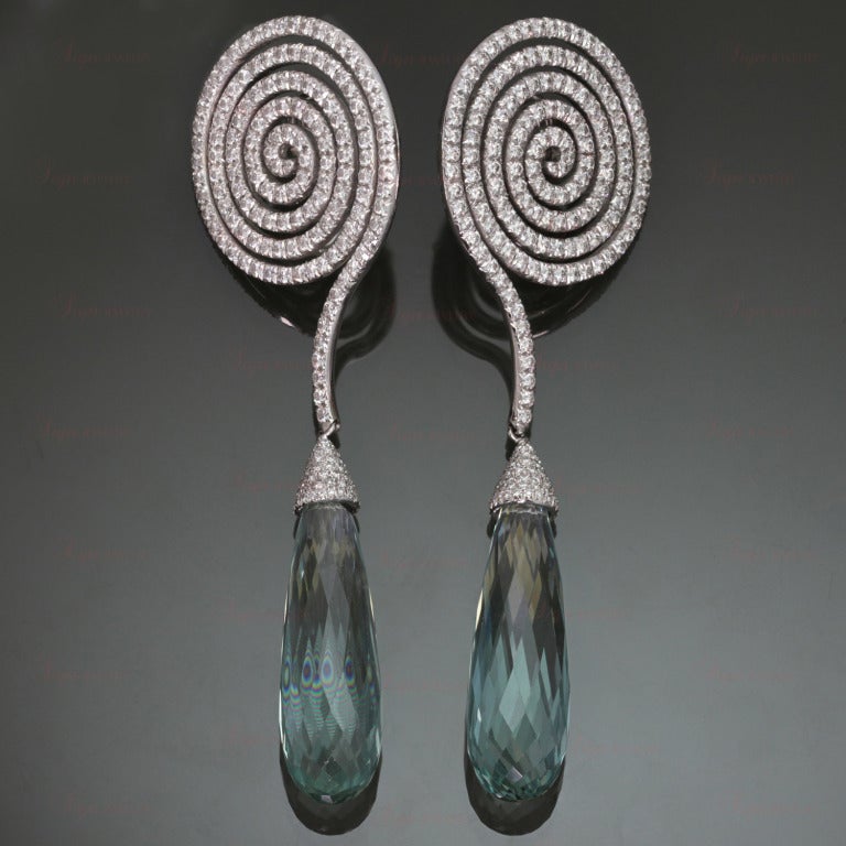These magnificent red-carpet dangling earrings are from the Escargot collection by Adler. Made in 18k white gold and set with 304 brilliant-cut . E-F VVS2-VS1 diamonds of 6.17 carats and 2 transparent light blue briolette-cut aquamarines of 60.92